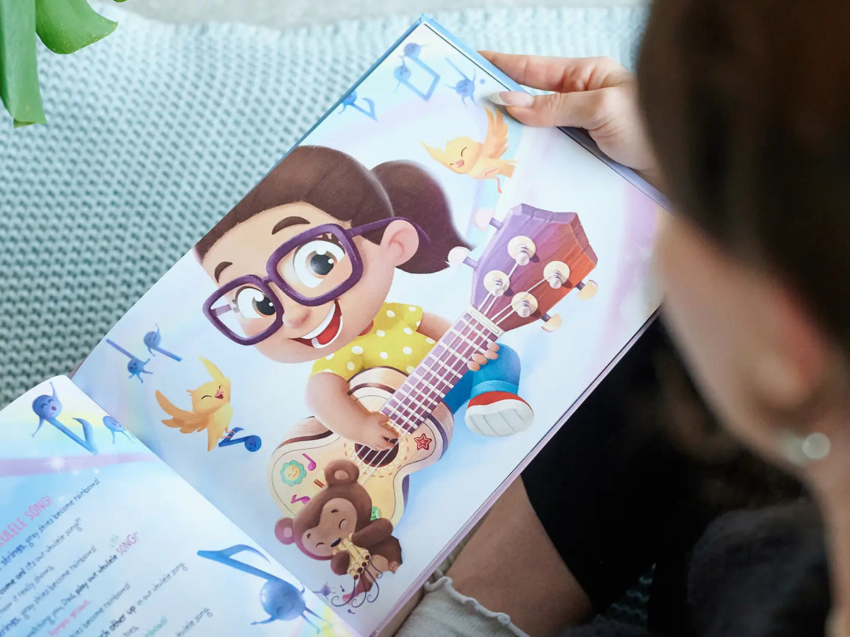 Illustration amusante d'une fille jouant de la guitare de notre livre personnalisé pour papa pour Noël.