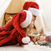 Deux filles profitant de leur livre de Noël personnalisé.