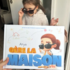 Une fille posant avec son nouveau livre personnalisé sur le fait d'être seule à la maison.