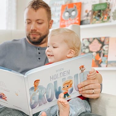 A couple kissing while holding their personalized book